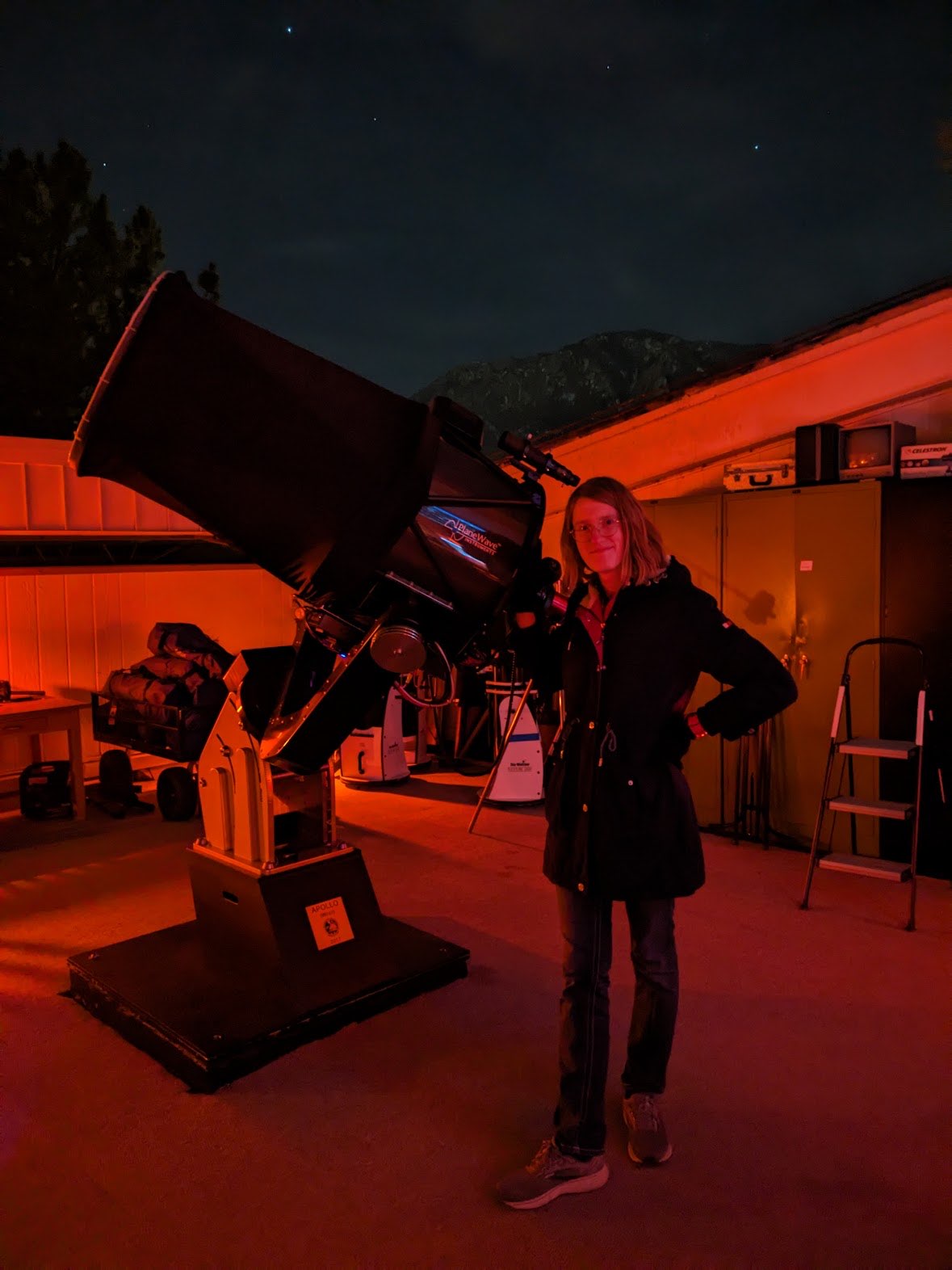 picture of autumn stephens next to a telescope